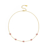 Gold necklace with pink gemstones on a white background