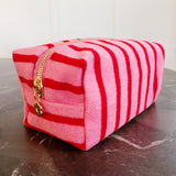 Soft terry cloth cosmetic case featuring bold, horizontal stripes and a compact zippered design—perfect for storing makeup, toiletries, or small travel essentials with a cozy, beach-ready flair.