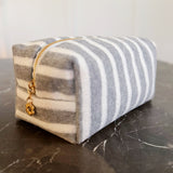 Soft terry cloth cosmetic case featuring bold, horizontal stripes and a compact zippered design—perfect for storing makeup, toiletries, or small travel essentials with a cozy, beach-ready flair.