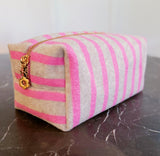 Soft terry cloth cosmetic case featuring bold, horizontal stripes and a compact zippered design—perfect for storing makeup, toiletries, or small travel essentials with a cozy, beach-ready flair.