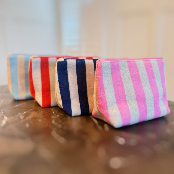 Versatile cosmetic pouch made from soft terry fabric with colorful striped detailing—perfect for storing makeup, toiletries, or everyday essentials on the go.