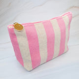 Versatile cosmetic pouch made from soft terry fabric with colorful striped detailing—perfect for storing makeup, toiletries, or everyday essentials on the go.