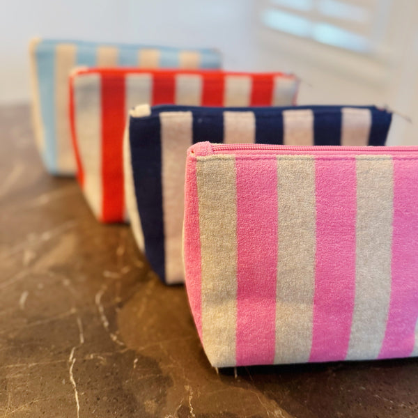 Versatile cosmetic pouch made from soft terry fabric with colorful striped detailing—perfect for storing makeup, toiletries, or everyday essentials on the go.