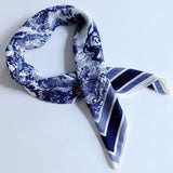 Lightweight textured square scarf with a soft finish, ideal for accessorizing hair, necklines, or handbags with effortless elegance.