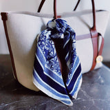 Lightweight textured square scarf with a soft finish, ideal for accessorizing hair, necklines, or handbags with effortless elegance.