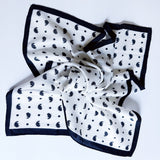 Lightweight textured square scarf with a soft finish, ideal for accessorizing hair, necklines, or handbags with effortless elegance.