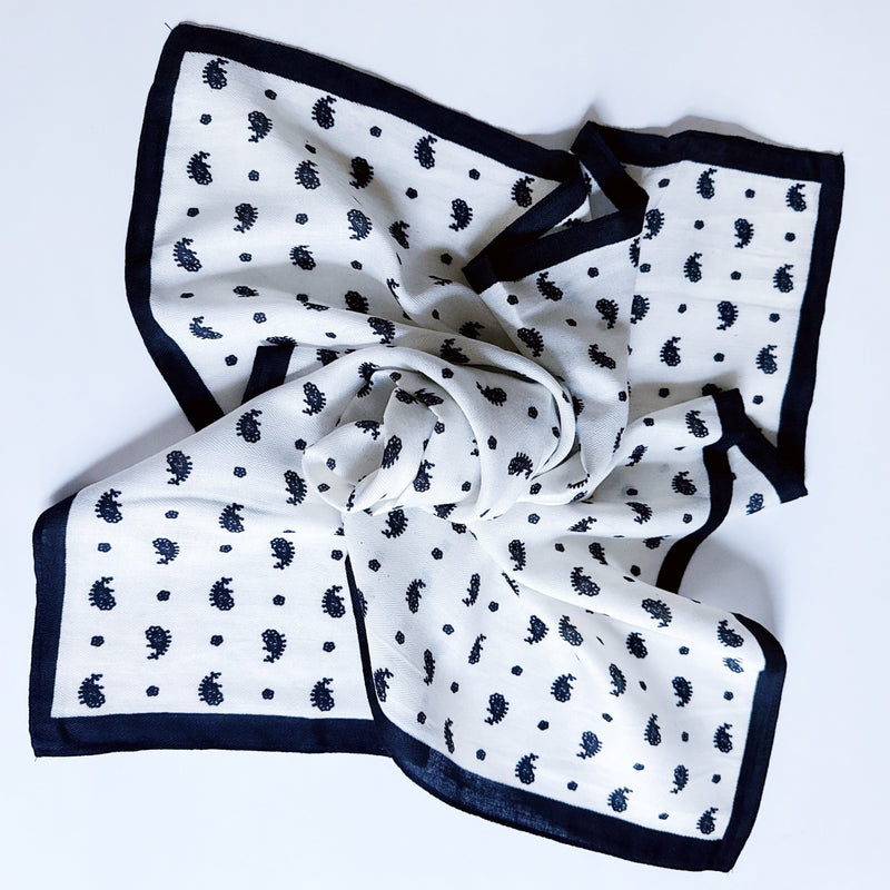 Lightweight textured square scarf with a soft finish, ideal for accessorizing hair, necklines, or handbags with effortless elegance.