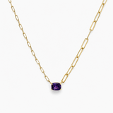 Gold necklace with a purple gemstone on a white background