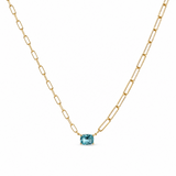 Gold necklace with a blue gemstone on a white background