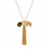 Gold necklace with tassel and horse head pendant on a white background