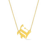 Gold-tone chain necklace featuring a bold Gothic-style initial charm that hangs asymmetrically to the side, adding a vintage-inspired yet edgy detail to your layered look.