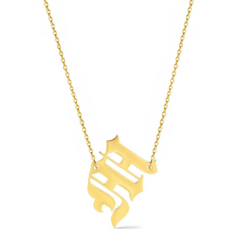 Gold-tone chain necklace featuring a bold Gothic-style initial charm that hangs asymmetrically to the side, adding a vintage-inspired yet edgy detail to your layered look.