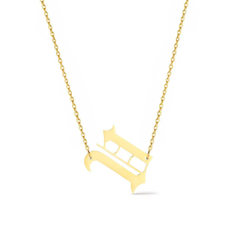 Gold-tone chain necklace featuring a bold Gothic-style initial charm that hangs asymmetrically to the side, adding a vintage-inspired yet edgy detail to your layered look.