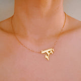 Gold-tone chain necklace featuring a bold Gothic-style initial charm that hangs asymmetrically to the side, adding a vintage-inspired yet edgy detail to your layered look.