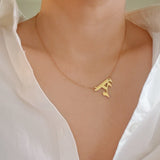 Gold-tone chain necklace featuring a bold Gothic-style initial charm that hangs asymmetrically to the side, adding a vintage-inspired yet edgy detail to your layered look.