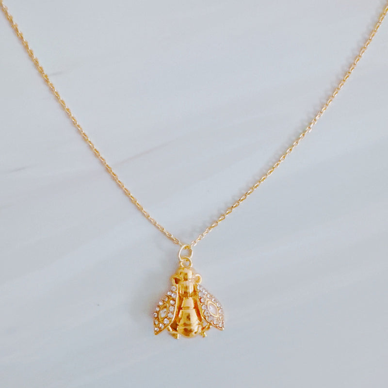 Gold-tone necklace featuring a vintage-style bee pendant with intricate detailing, offering a classic and nature-inspired look.