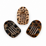Three tortoiseshell patterned hair clips on a white background