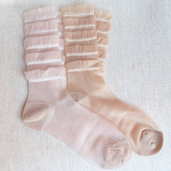 Set of two socks adorned with cascading tulle lace detailing, adding a soft, romantic flair to any look.