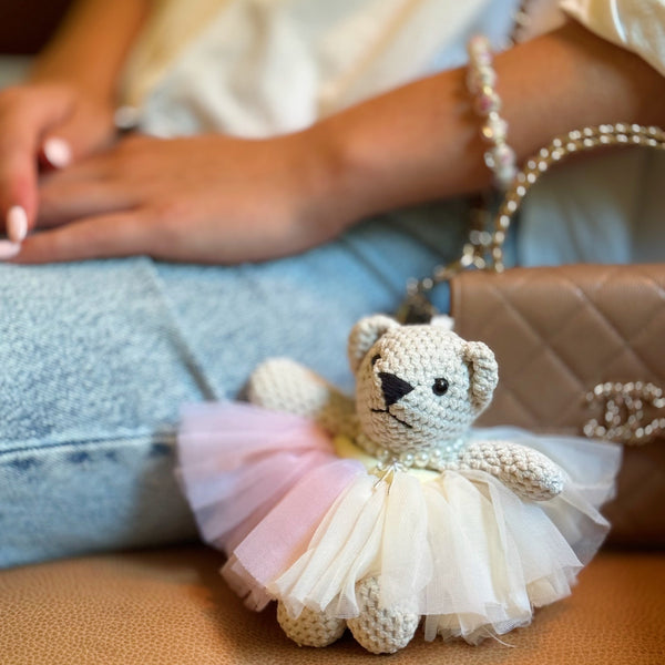  Adorable bag charm featuring a ballerina bear dressed in a tutu with a scrunchie-style attachment—adding a whimsical and playful touch to any bag or backpack.