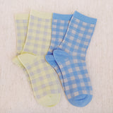 Set of two charming socks featuring classic gingham patterns with subtle twinkle accents, blending playful style with cozy everyday comfort.