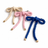Rope-style hair clip in a sculptural bow shape, featuring a textured twisted design that adds playful elegance and volume to any hairstyle.