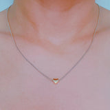 Delicate two-tone necklace featuring a petite heart pendant with a metal finish on a fine chain.