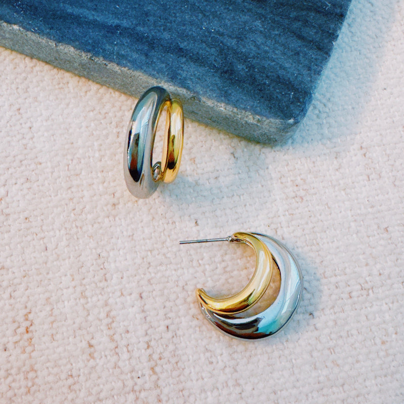 Stylish two-toned hoop earrings featuring paired gold and silver finishes in a sleek, modern design.