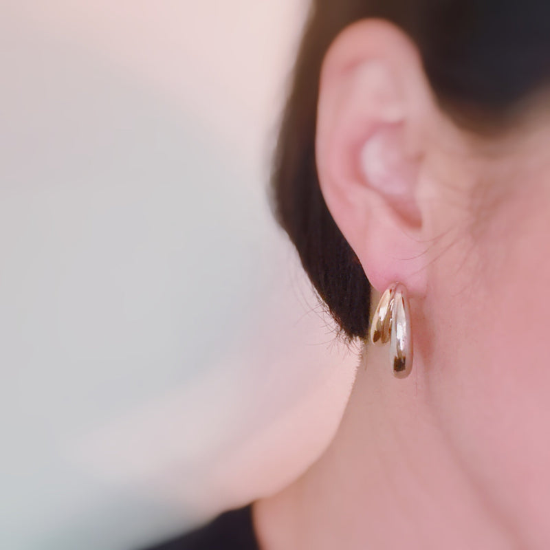 Stylish two-toned hoop earrings featuring paired gold and silver finishes in a sleek, modern design.