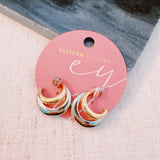 Stylish two-toned hoop earrings featuring paired gold and silver finishes in a sleek, modern design.