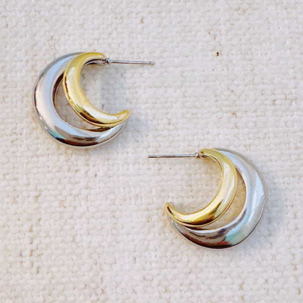 Stylish two-toned hoop earrings featuring paired gold and silver finishes in a sleek, modern design.