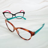 Two pairs of eyeglasses with different frame designs on a light background