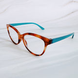 Eyeglasses with tortoiseshell frame and blue arms on a white background