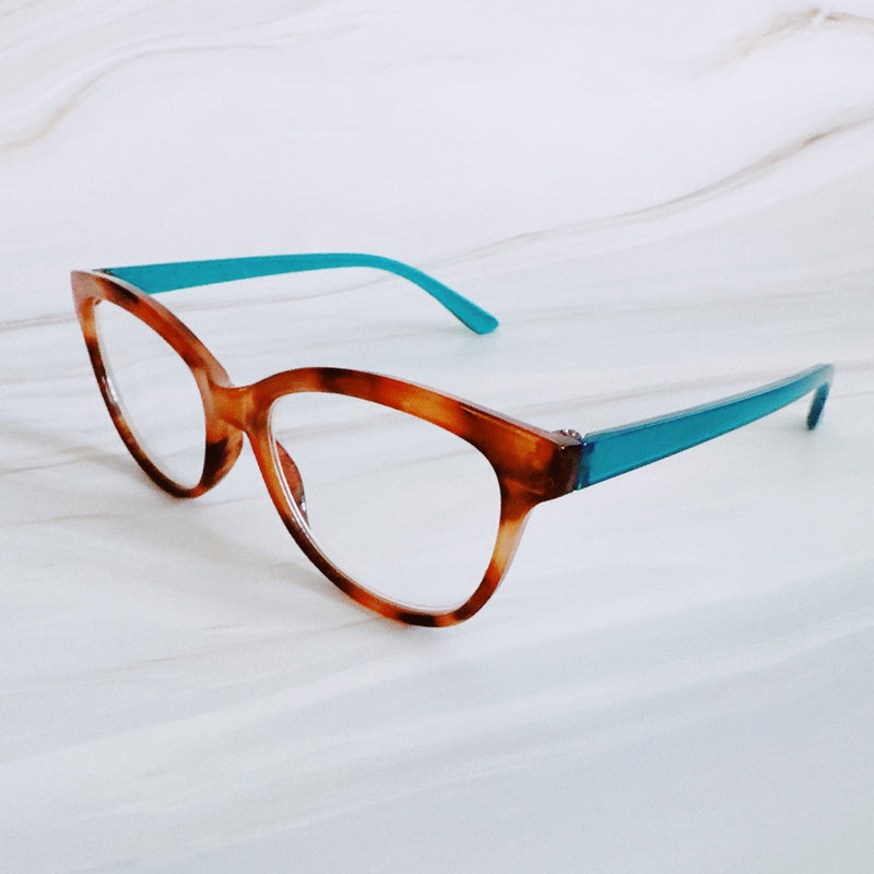 Eyeglasses with tortoiseshell frame and blue arms on a white background