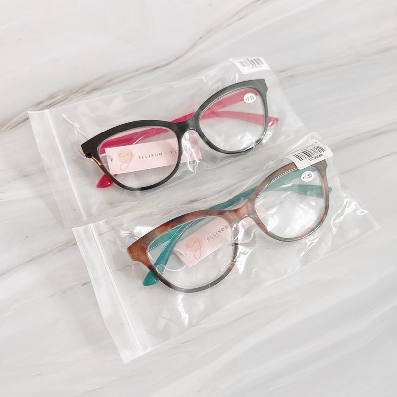 Two pairs of eyeglasses in clear packaging