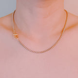 Silver-tone U-link chain necklace featuring a bold, gold lock pendant for a modern, edgy statement.