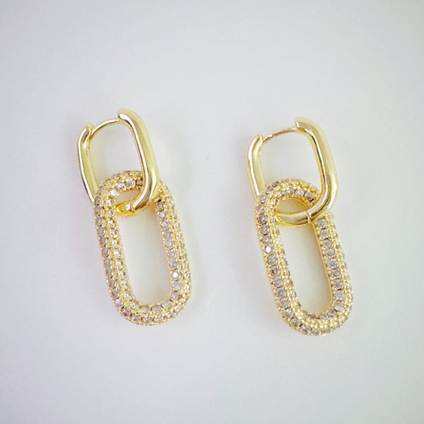 Sleek gold-tone drop earrings featuring modern rectangular chain links with a polished finish, and a sparkling link creating a bold yet refined statement for everyday or evening wear.