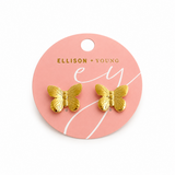 Gold butterfly earrings on a pink Ellison & Young branded card