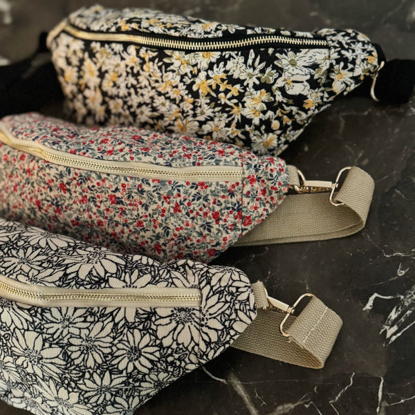 floral sling bag with adjustable strap and front zipper, available in Cherry Meadow, Indigo Bloom, and Midnight Daisy prints
