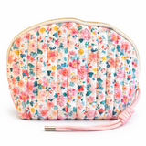 Quilted cosmetic case featuring a vintage-inspired floral print with soft padding and a structured shape, designed for storing makeup and small essentials.