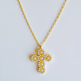 Elegant vintage-inspired necklace featuring a delicate cross pendant adorned with lustrous pearls and intricate detailing. Suspended from a fine chain, this piece blends timeless charm with a touch of sophistication—ideal for both faith-inspired style and classic fashion statements.