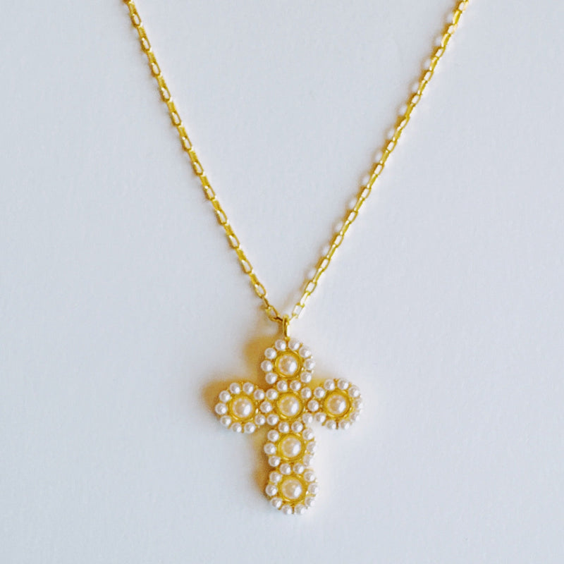 Elegant vintage-inspired necklace featuring a delicate cross pendant adorned with lustrous pearls and intricate detailing. Suspended from a fine chain, this piece blends timeless charm with a touch of sophistication—ideal for both faith-inspired style and classic fashion statements.