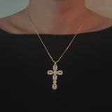 Gold-tone necklace featuring a vintage-inspired cross pendant adorned with sparkling crystals for a timeless and elegant look.