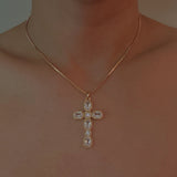 Gold-tone necklace featuring a vintage-inspired cross pendant adorned with sparkling crystals for a timeless and elegant look.
