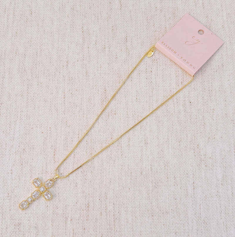 Gold-tone necklace featuring a vintage-inspired cross pendant adorned with sparkling crystals for a timeless and elegant look.