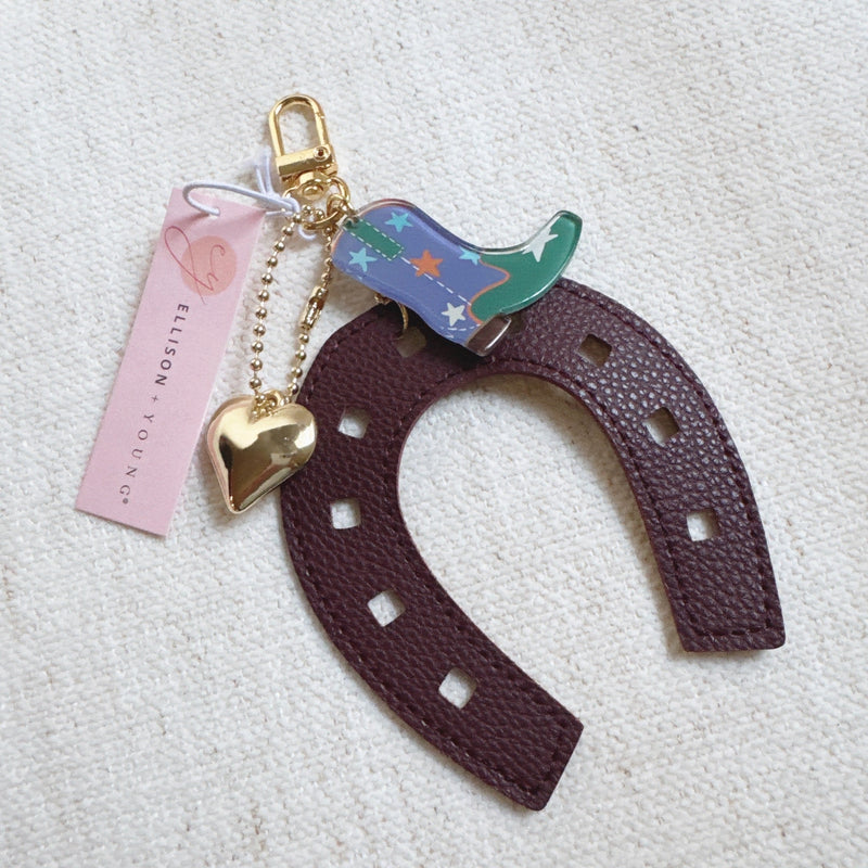 Purple horseshoe bag charm with a colorful boot and golden star – lucky western theme