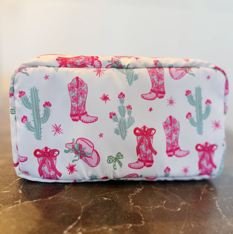 Compact cosmetic case with a playful Western-inspired design, ideal for daily use—featuring a zip closure and spacious interior to keep your beauty essentials organized in style
