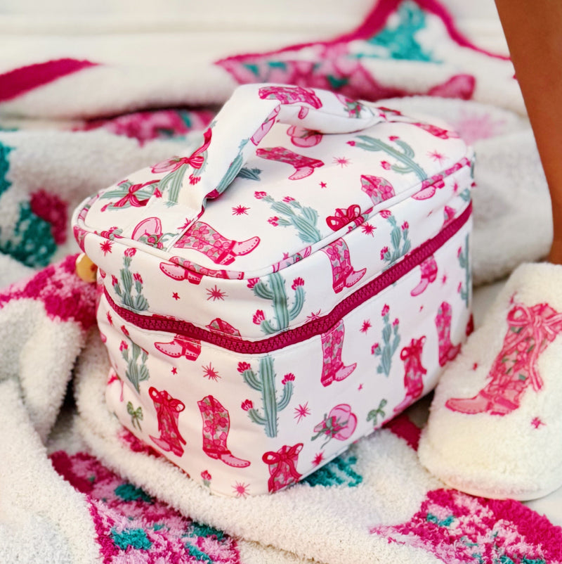 Stylish travel cosmetic case featuring a Western-inspired design with whimsical details, sturdy zip closure, and a convenient top handle—perfect for organizing beauty essentials on the go.