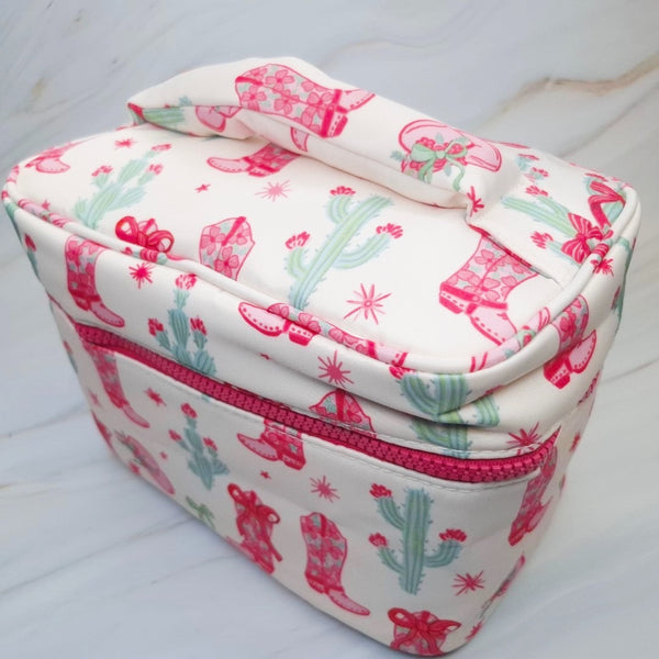Stylish travel cosmetic case featuring a Western-inspired design with whimsical details, sturdy zip closure, and a convenient top handle—perfect for organizing beauty essentials on the go.