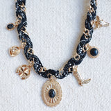 Chain necklace woven with printed scarf fabric, adorned with Western-themed charms including a boot, sunburst, and sheriff star.