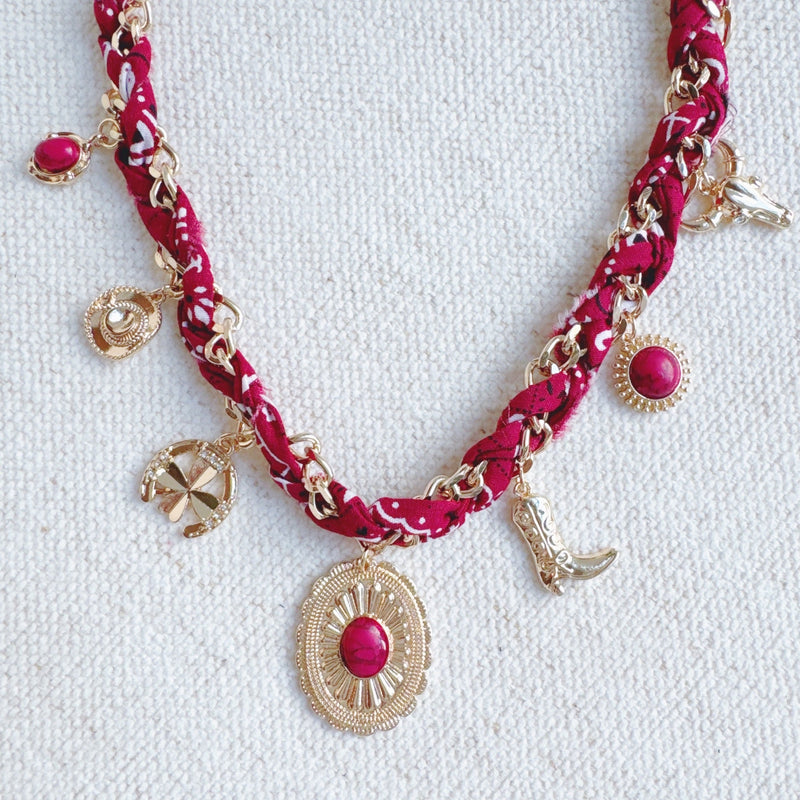 Chain necklace woven with printed scarf fabric, adorned with Western-themed charms including a boot, sunburst, and sheriff star.